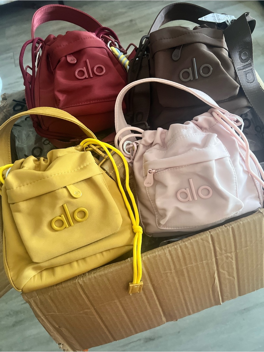 ALO Yoga Mini Drawstring Bucket Bag Trio โ Yellow, Pink, Red, Brown